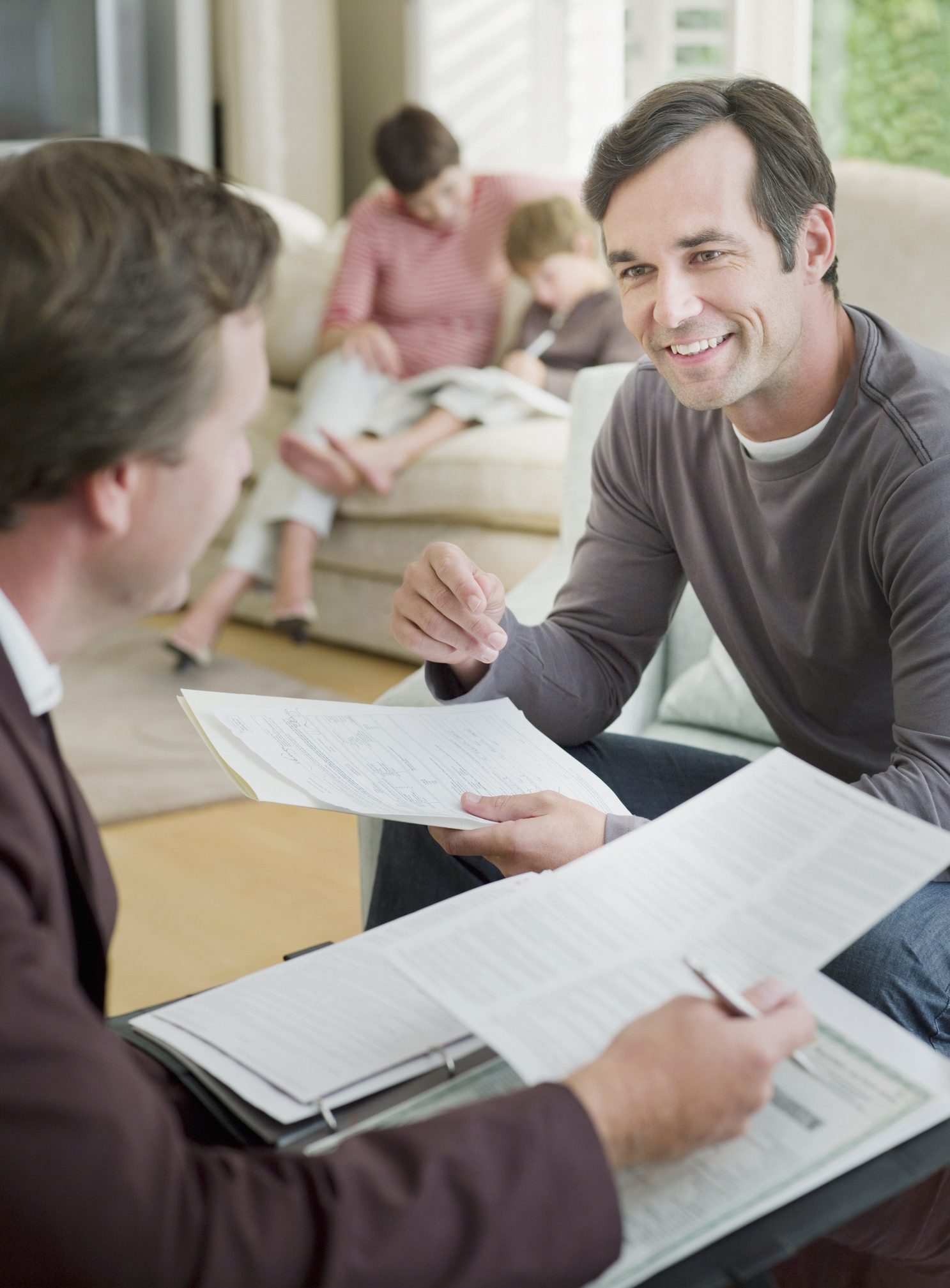 Man meeting with financial advisor in living room